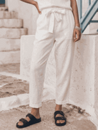Woman wearing relaxed cotton-linen set with short-sleeve top and straight-leg pants in monochrome tones