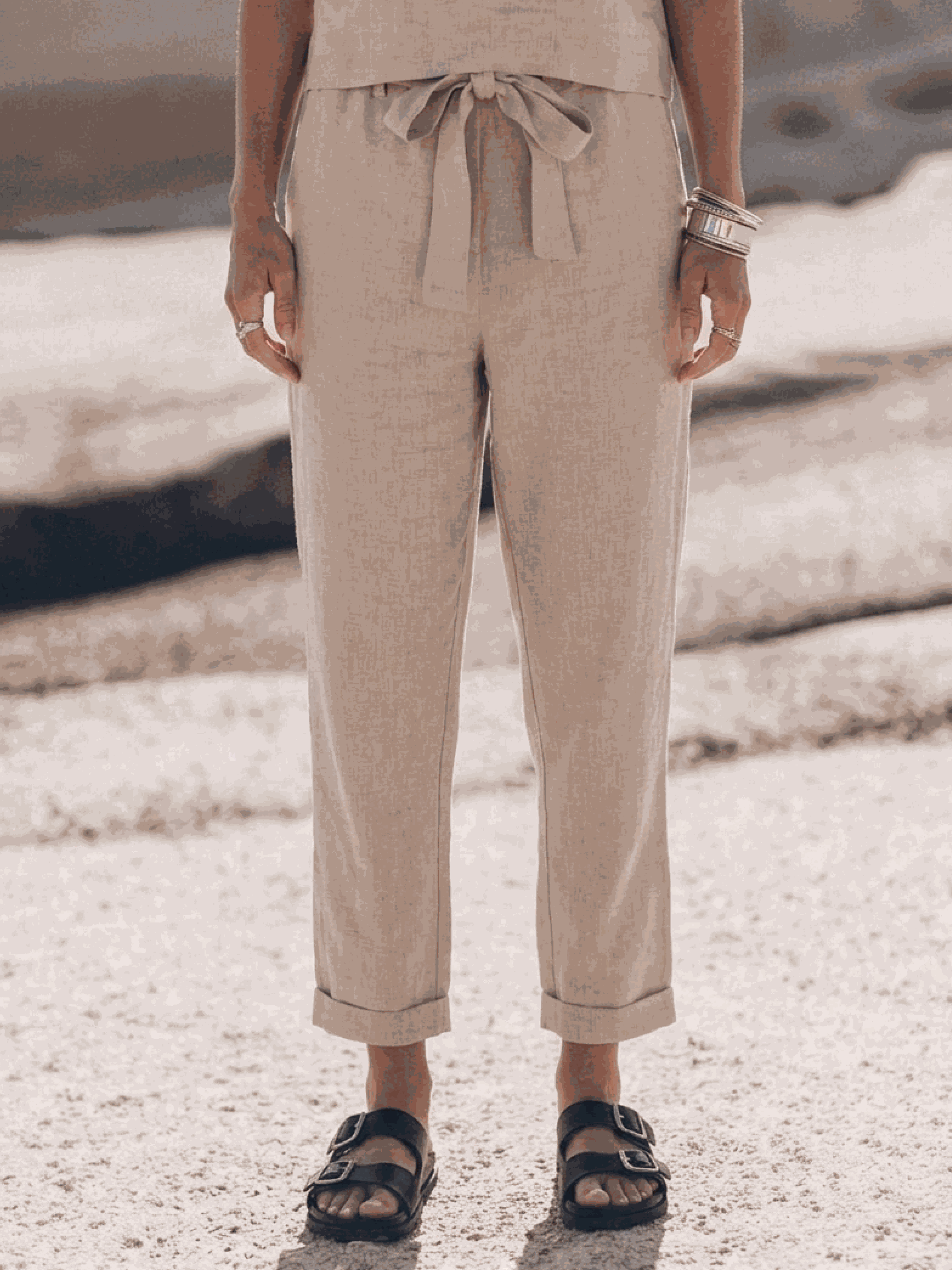 neutral-toned cotton-linen set with relaxed short-sleeve top and straight-leg pants on white background