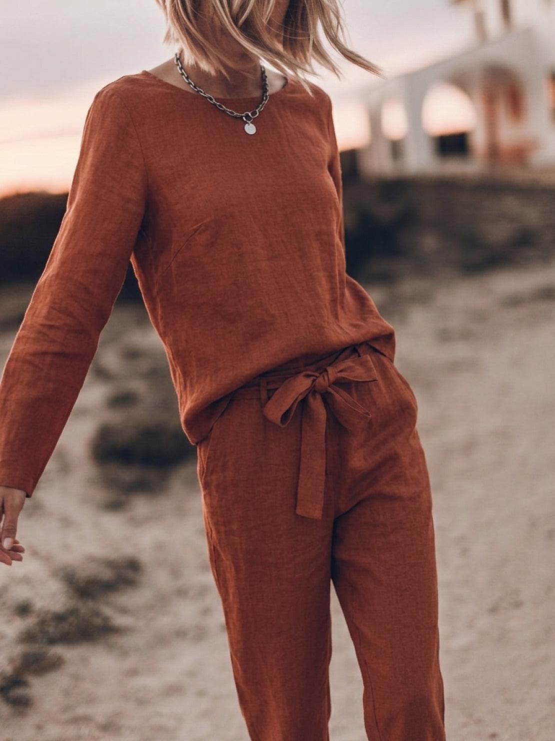 Model wearing a relaxed cotton-linen monochrome capsule outfit with longline top and wide-leg pants