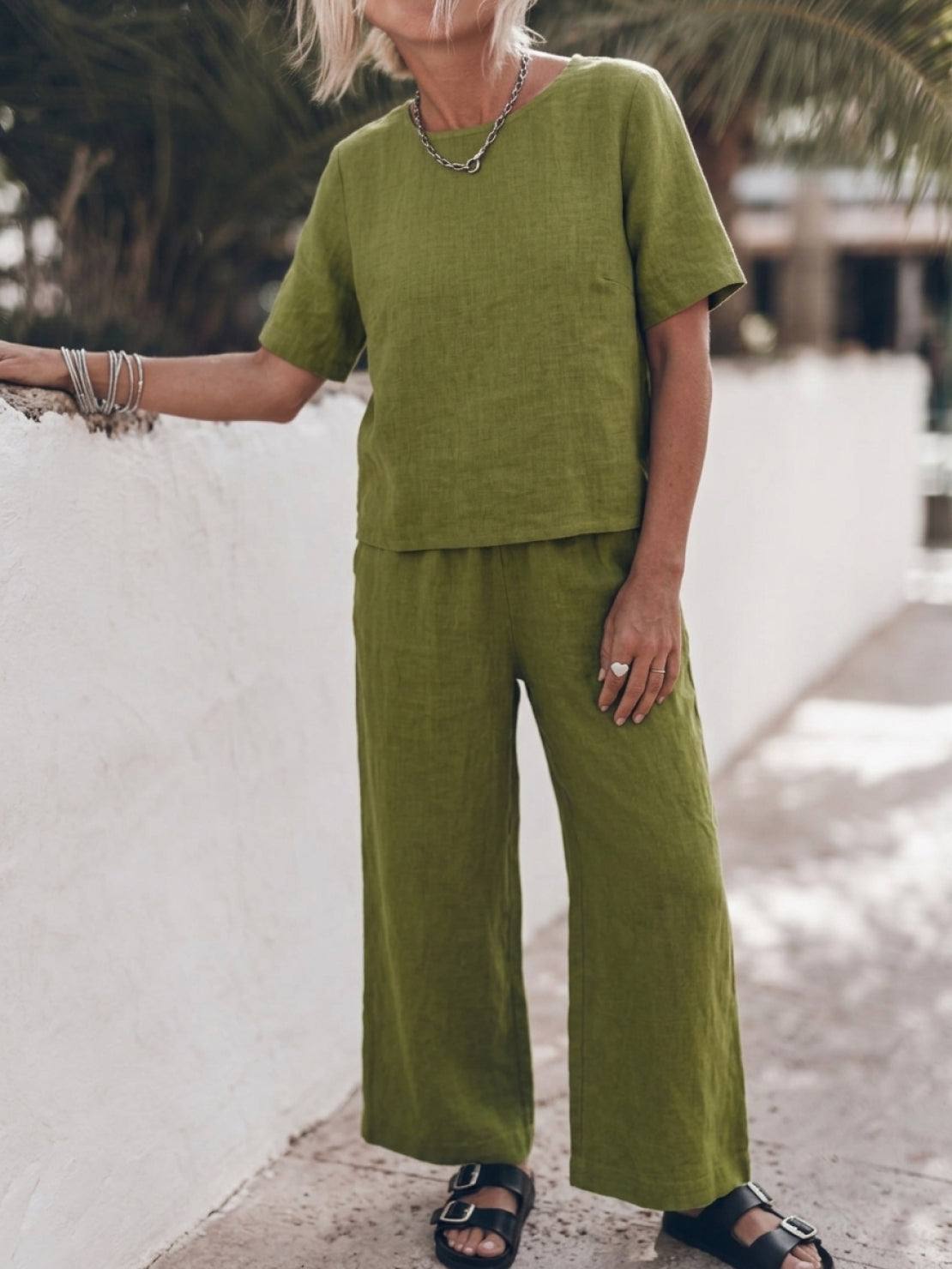 Woman wearing loose fit co-ord set with soft-tailored top and wide-leg bottoms in breathable cotton