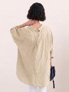 Oversized linen shirt in white with relaxed fit and button detailing on back