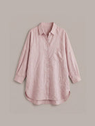 oversized relaxed cotton linen shirt with dropped shoulders and back pleat detail on white background