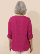 white pure linen age-defying shirt with button detail on wooden hanger