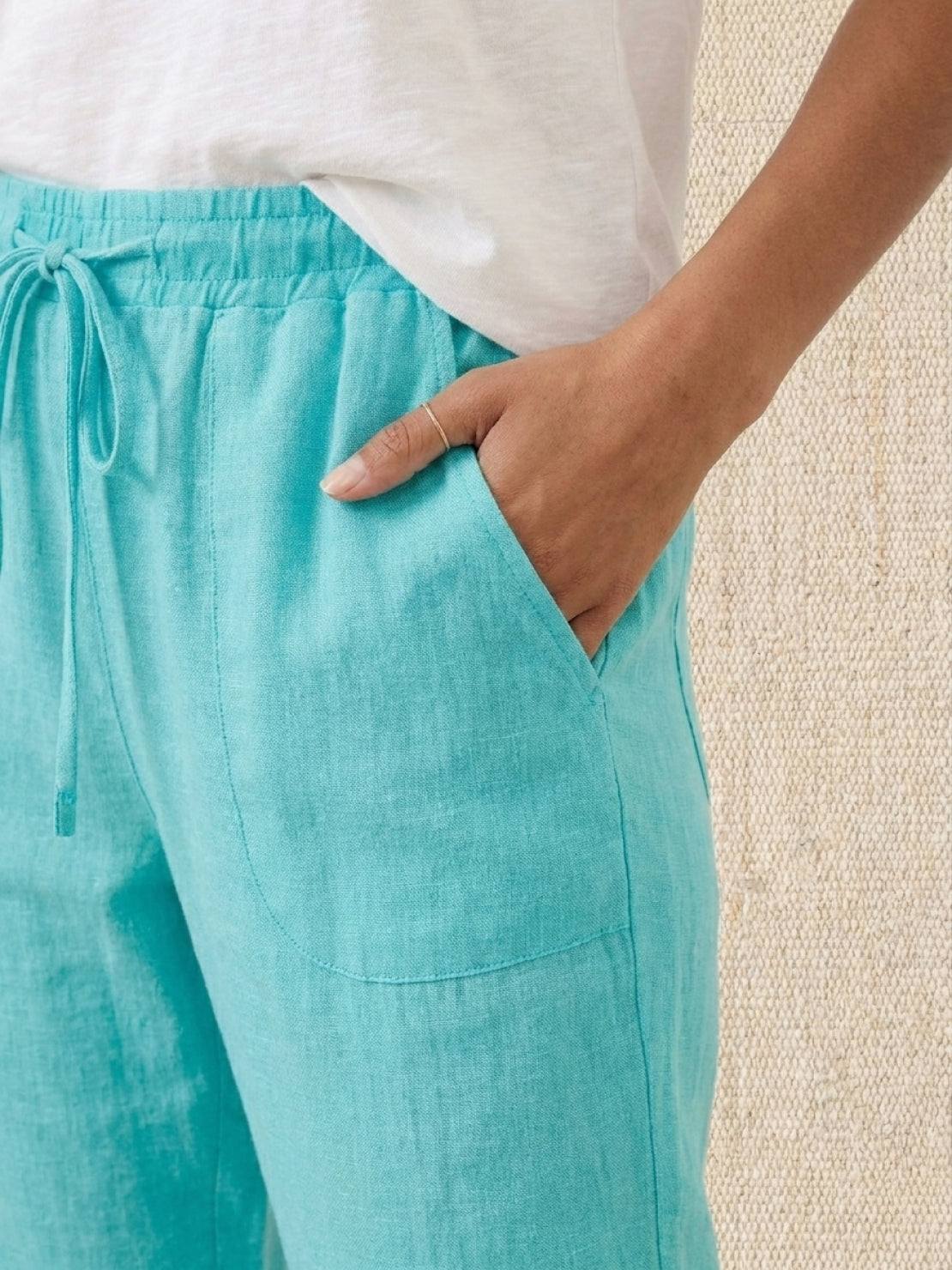 woman wearing relaxed chic elastic ankles pants standing outdoors with hands in pockets