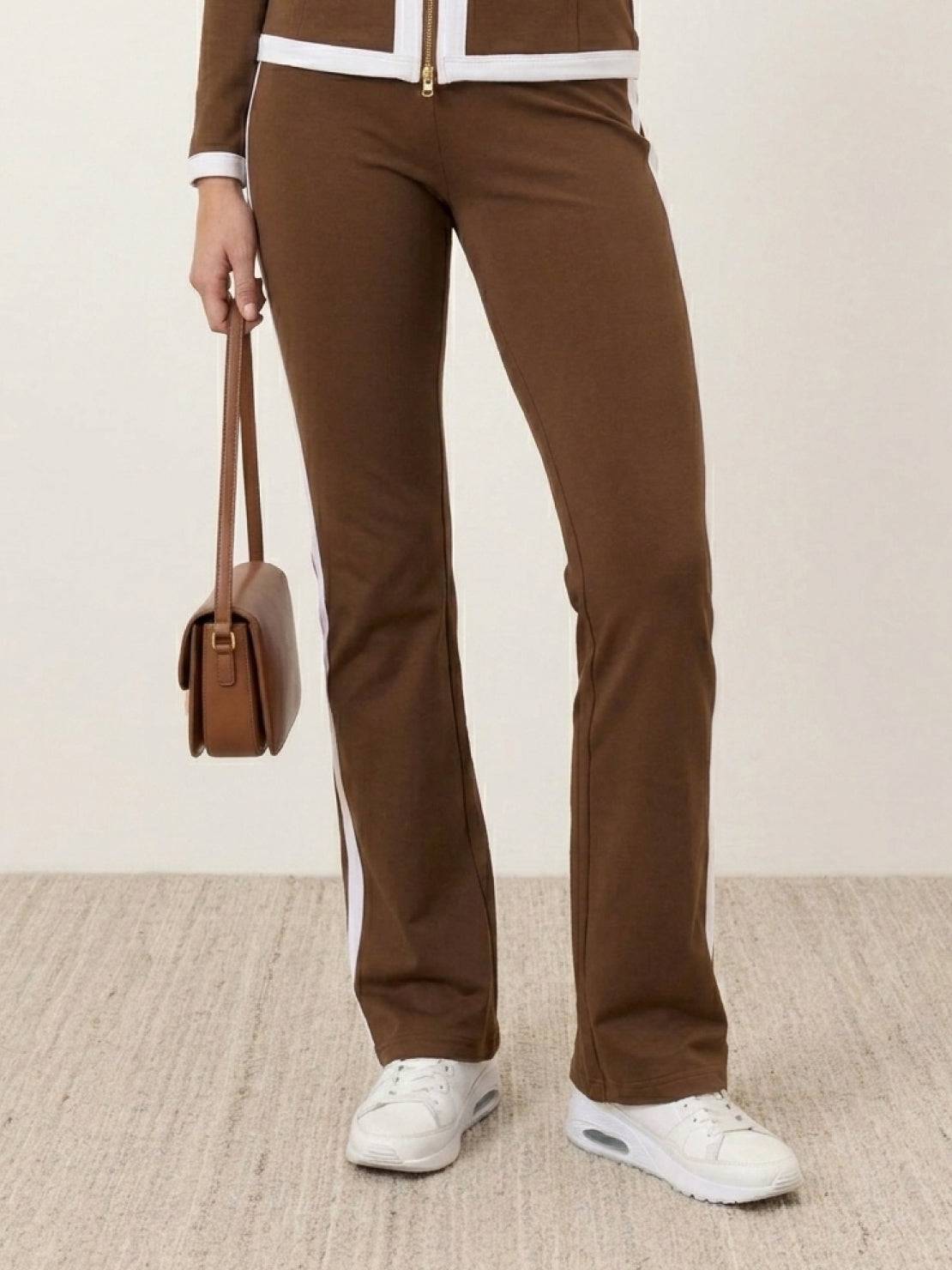 Woman modeling sleek contrast zip two-piece outfit with flattering silhouette and soft stretch fabric