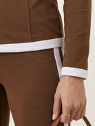 Woman wearing sleek contrast zip two-piece outfit in neutral tones