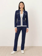 woman wearing sleek black contrast zip two-piece outfit standing outdoors