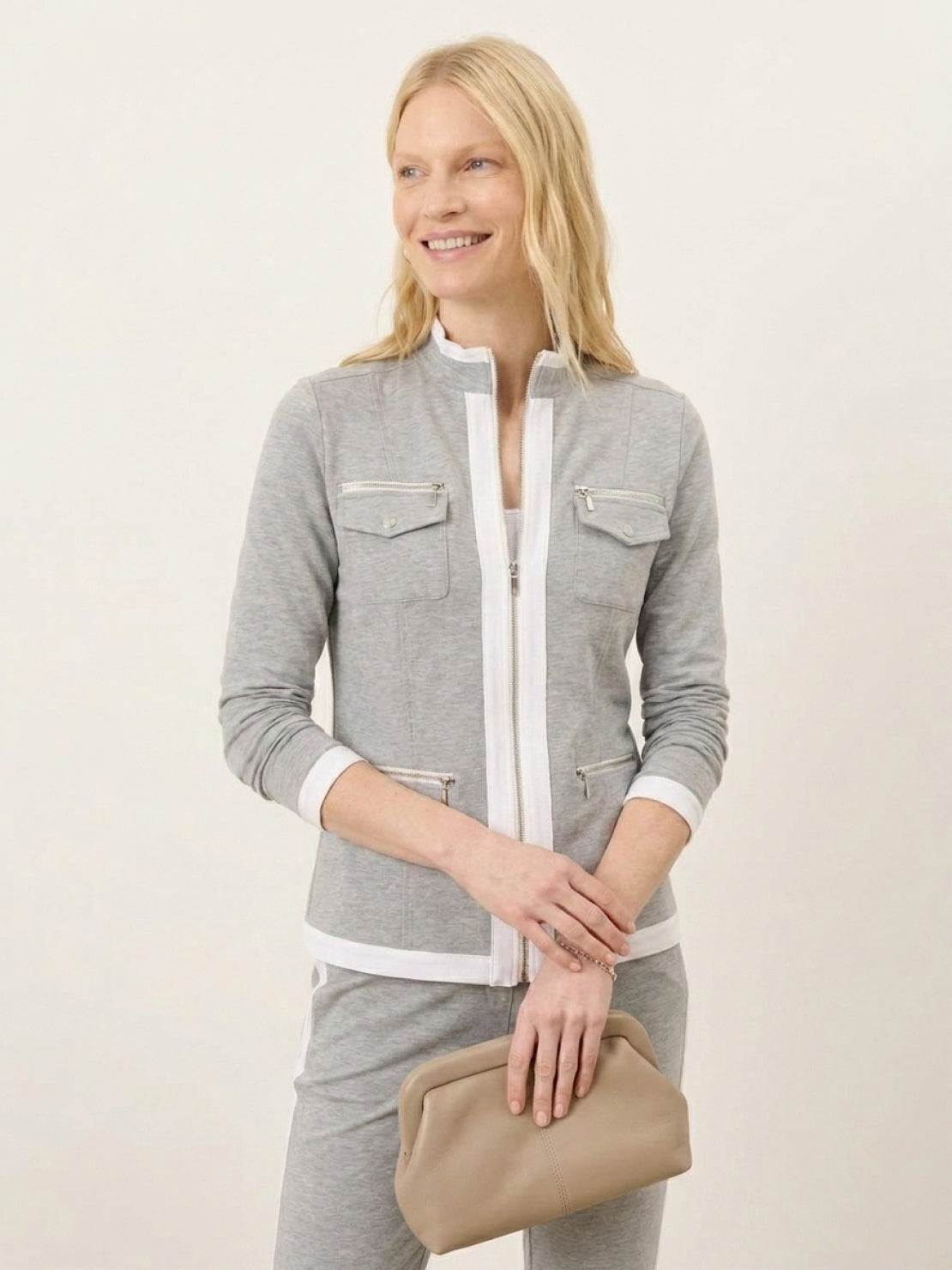 Woman wearing sleek contrast zip two-piece outfit with soft stretch fabric and slimming silhouette