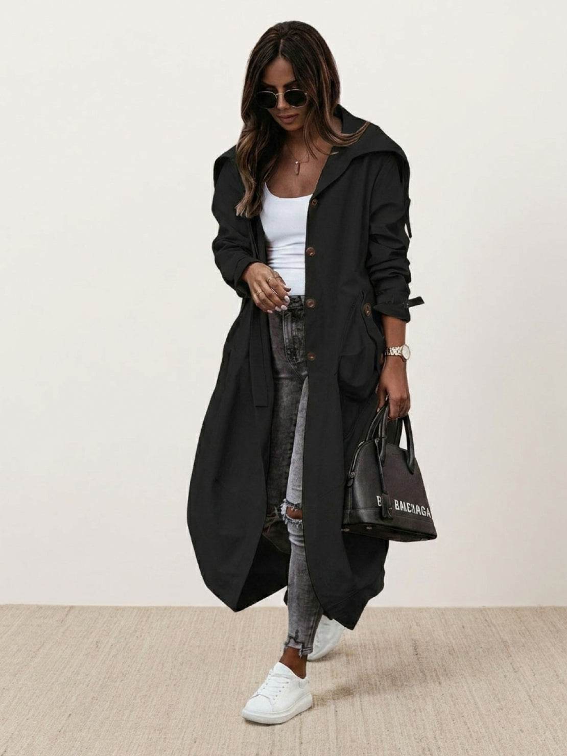 sleek minimalist oversized hooded coat in black on hanger for travel and layering