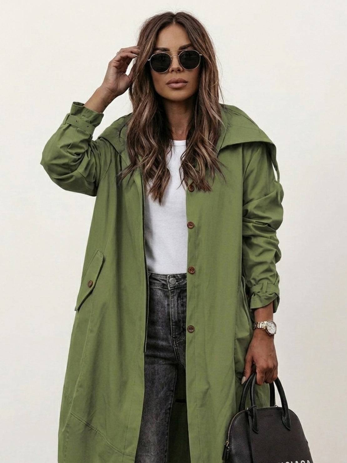 plus size minimalist hooded coat in black with oversized fit on hanger against white background
