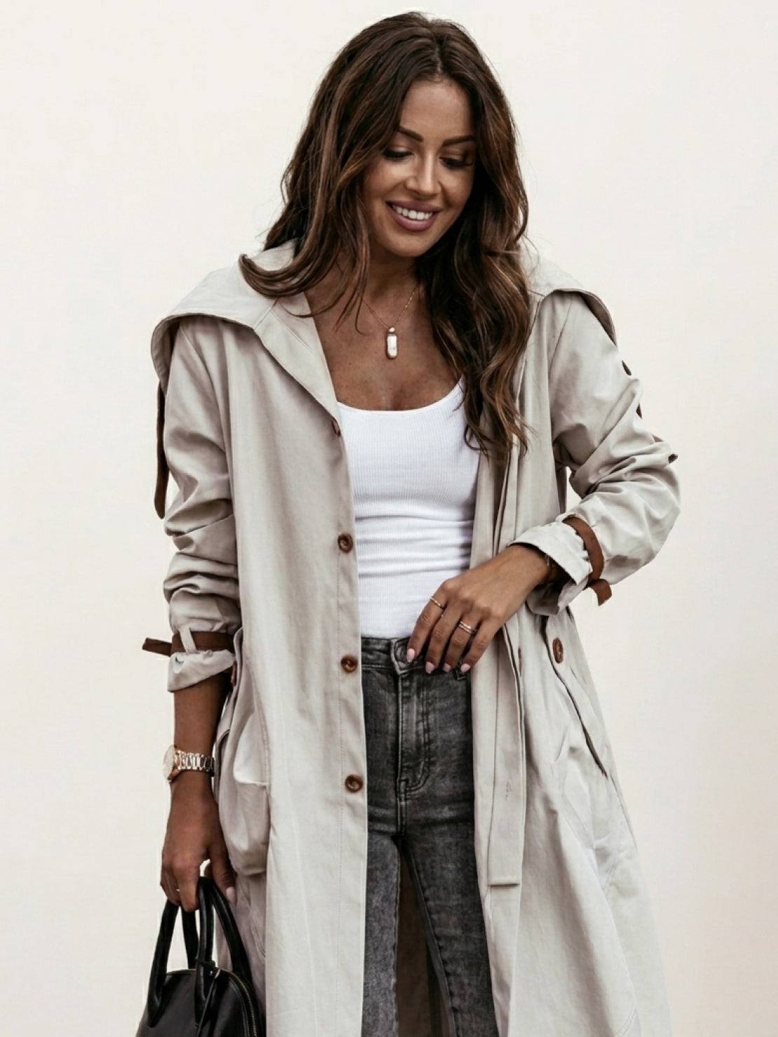 Minimalist hooded coat with sleek oversized fit for travel and lightweight warmth