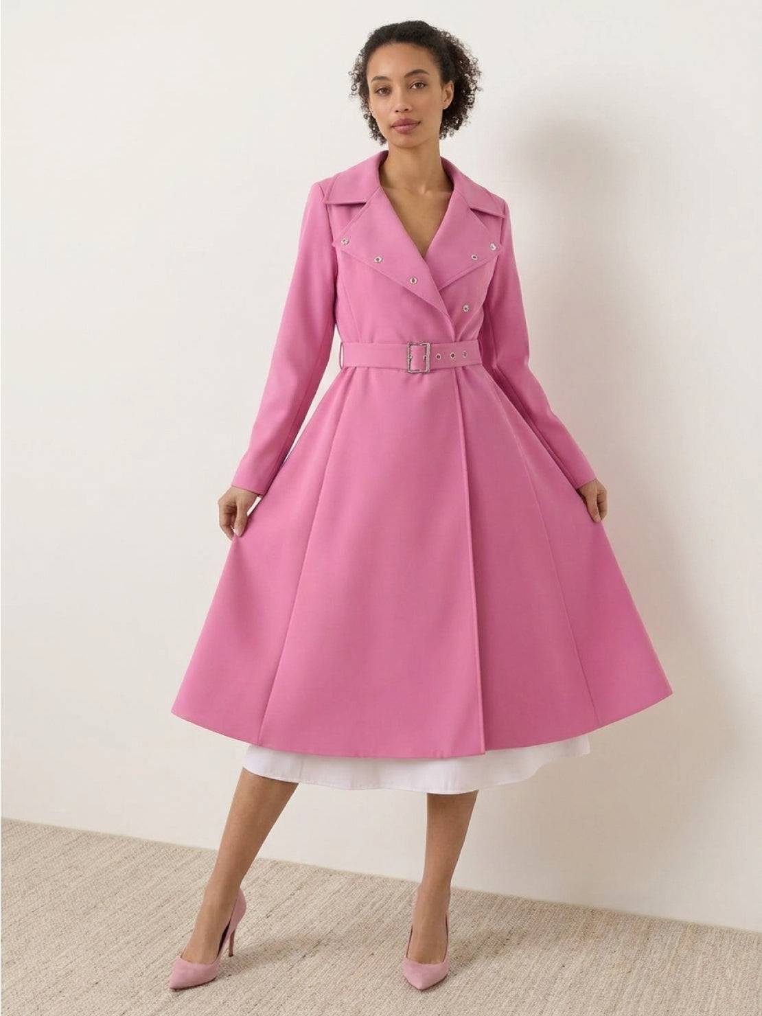 Woman wearing water-repellent A-line hooded raincoat with belt