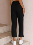 woman wearing relaxed fit straight pants in multiple colors demonstrating supreme comfort and stylish fit