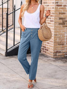 Woman wearing casual button-down utility-chic trousers with deep pockets and rolled cuffs