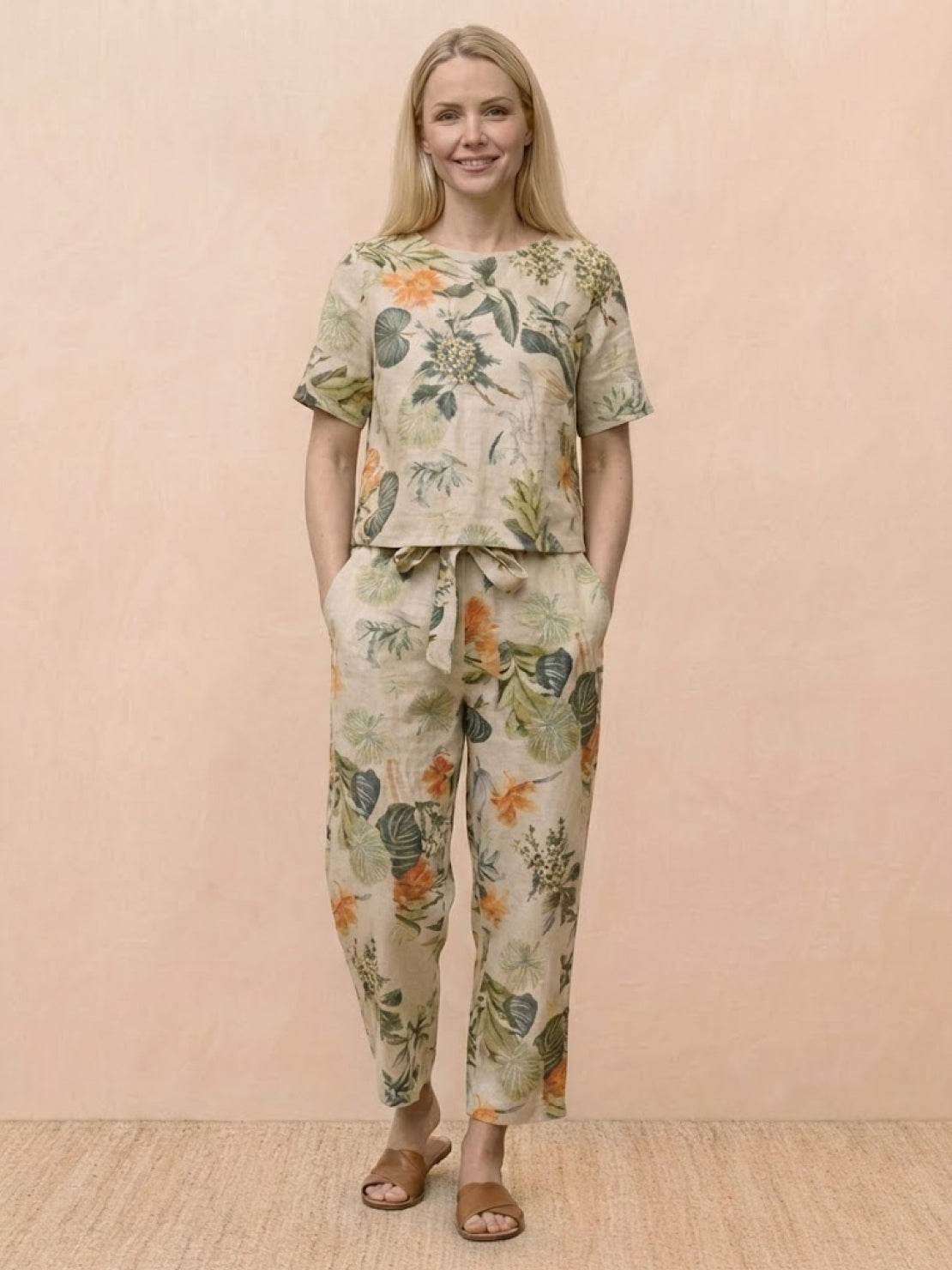 Model wearing relaxed 100% cotton linen set in monochrome with short-sleeve top and straight-leg pants