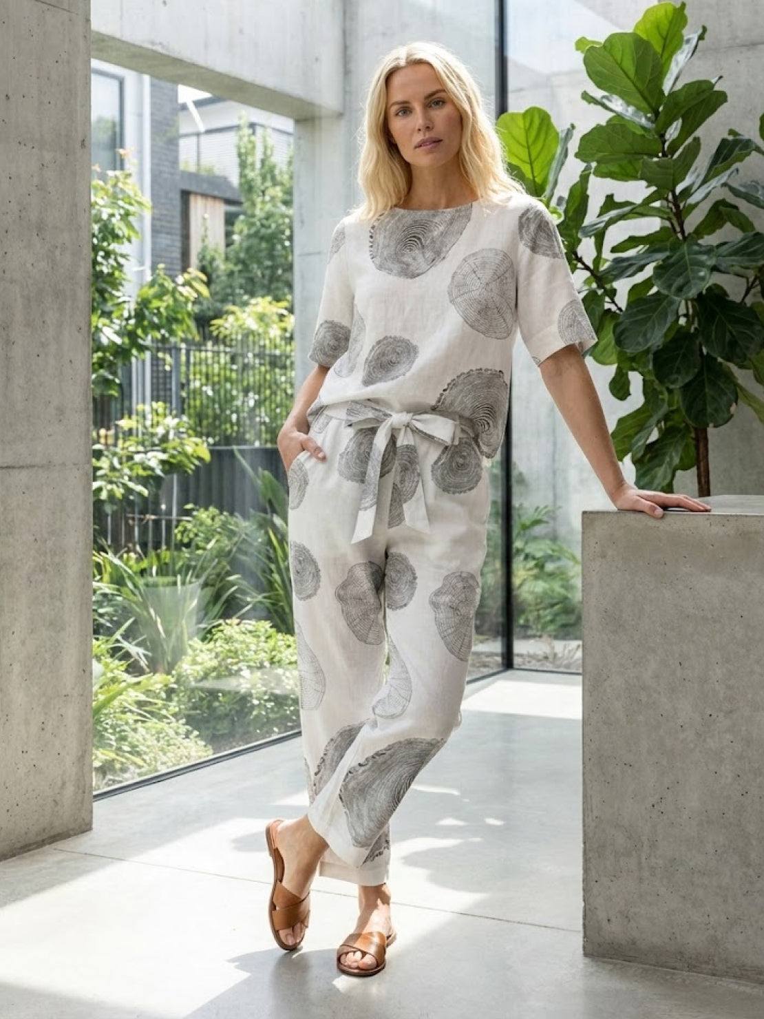 Woman wearing a breathable cotton linen set with relaxed short-sleeve top and straight-leg pants in monochrome tones