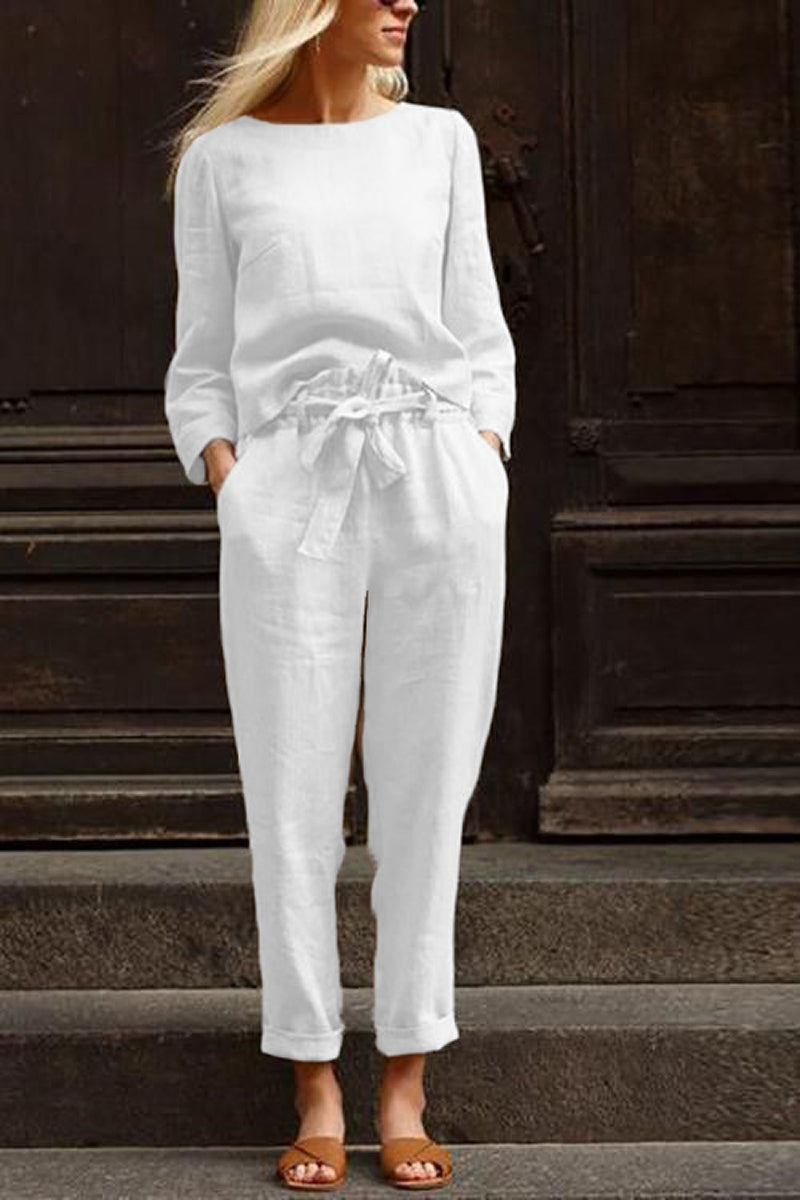 Woman wearing white relaxed longline top and wide-leg pants cotton-linen monochrome capsule outfit