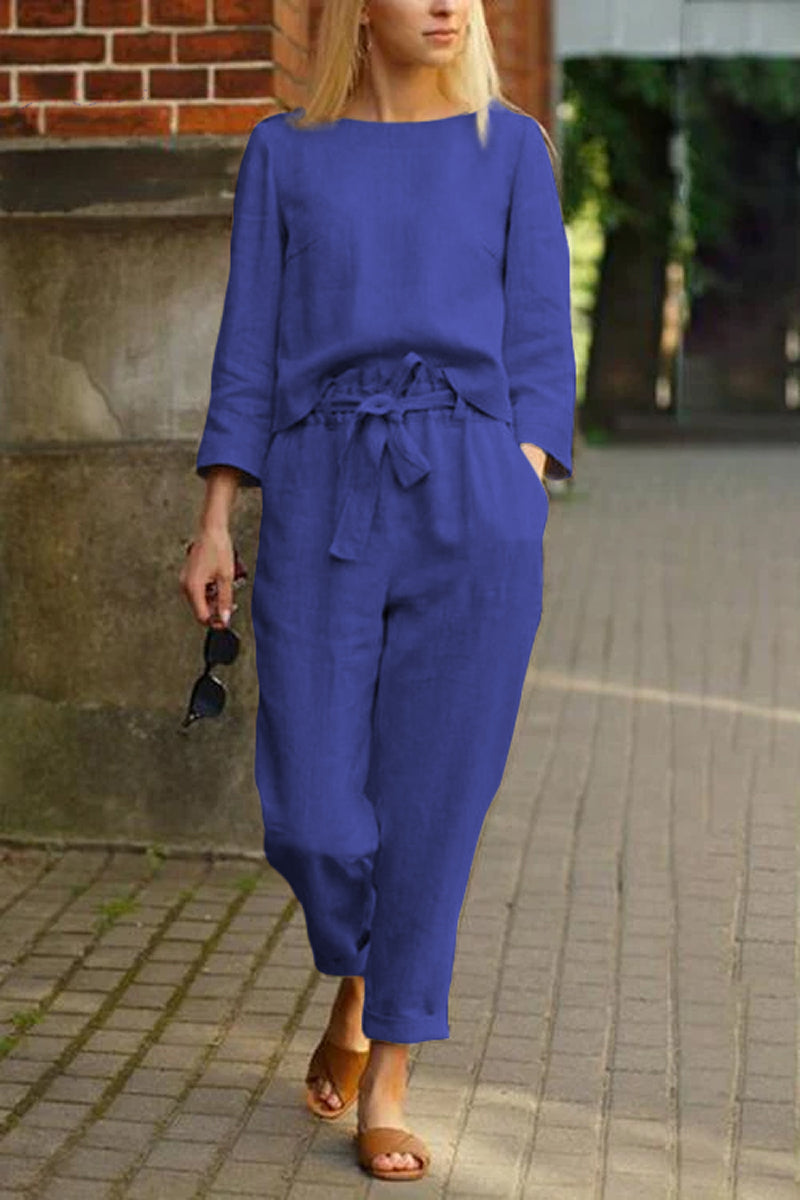woman wearing blue cotton-linen monochrome relaxed longline top and wide-leg pants walking outdoors