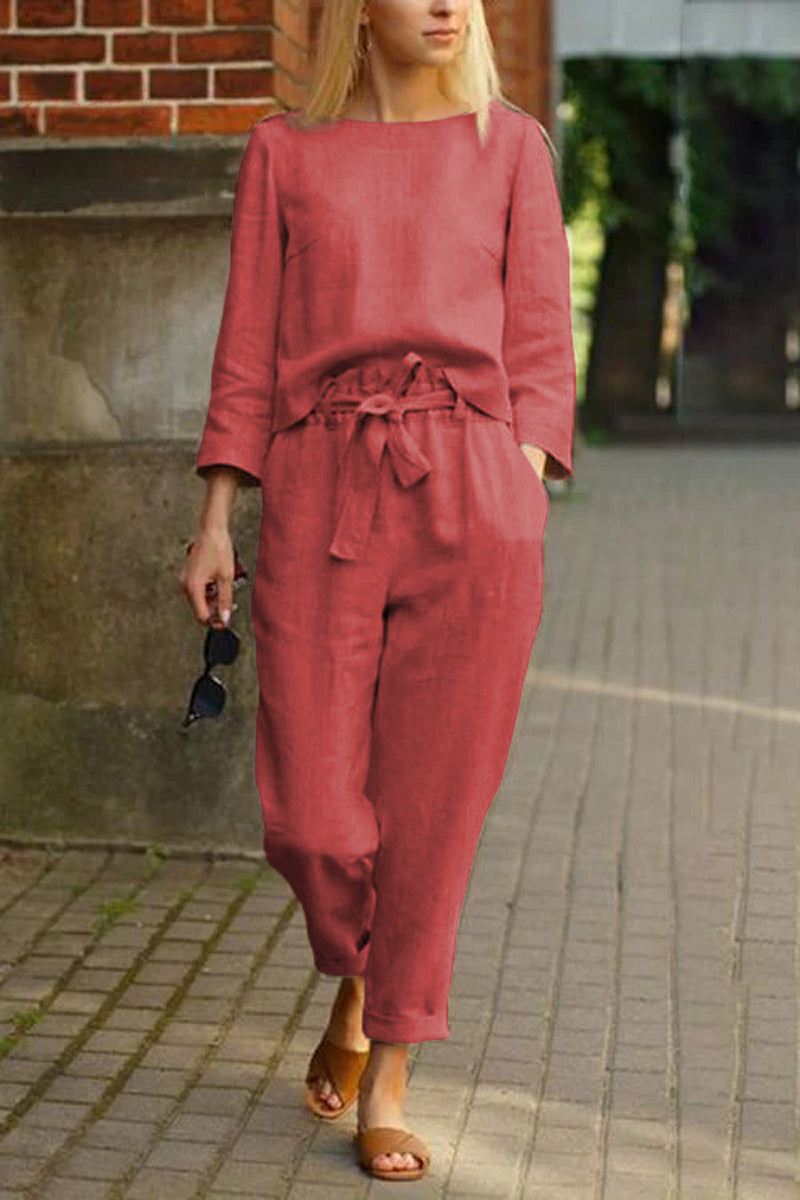 Woman wearing relaxed fit red cotton-linen monochrome capsule set with longline top and wide-leg pants walking outdoors