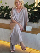 Woman wearing elegant layers two-piece set with layered V-neck top and matching pants