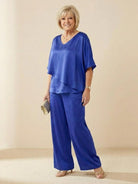 Woman wearing elegant layers two-piece set with V-neck and flared sleeves in soft fabric