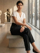 Woman wearing black high-waist wrapped comfy pants with loose fit and side pocket, styled for casual outdoor look