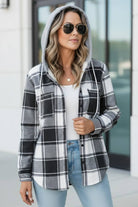 Woman wearing Highland Plaid Shacket with gray hood and black white plaid pattern