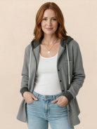 Highland Plaid Shacket with fleece lining, attached hood, button-front, and front pockets in classic plaid pattern