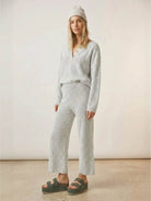 Woman wearing multi-weather comfort two-piece oversized set with cropped wide pants and long-sleeve top in casual stylish outfit