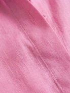 Model wearing oversized 100% cotton shirt and wide-leg pants co-ord set in relaxed white style