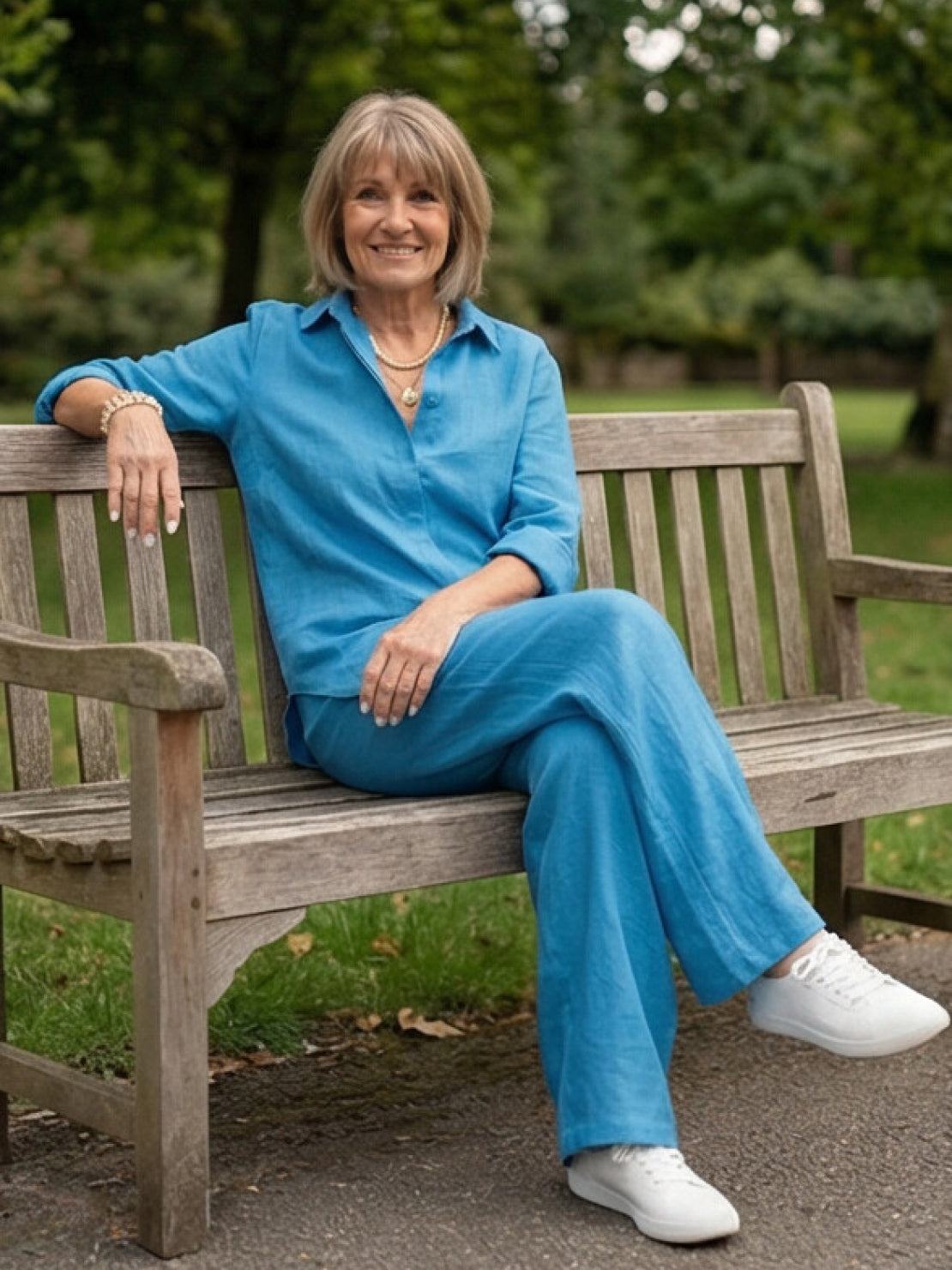 Woman wearing a monochrome relaxed shirt and trousers two-piece set standing outdoors
