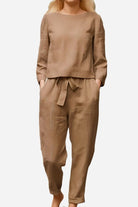 Woman wearing a brown 100% cotton linen monochrome two-piece set with long sleeves and tapered pants