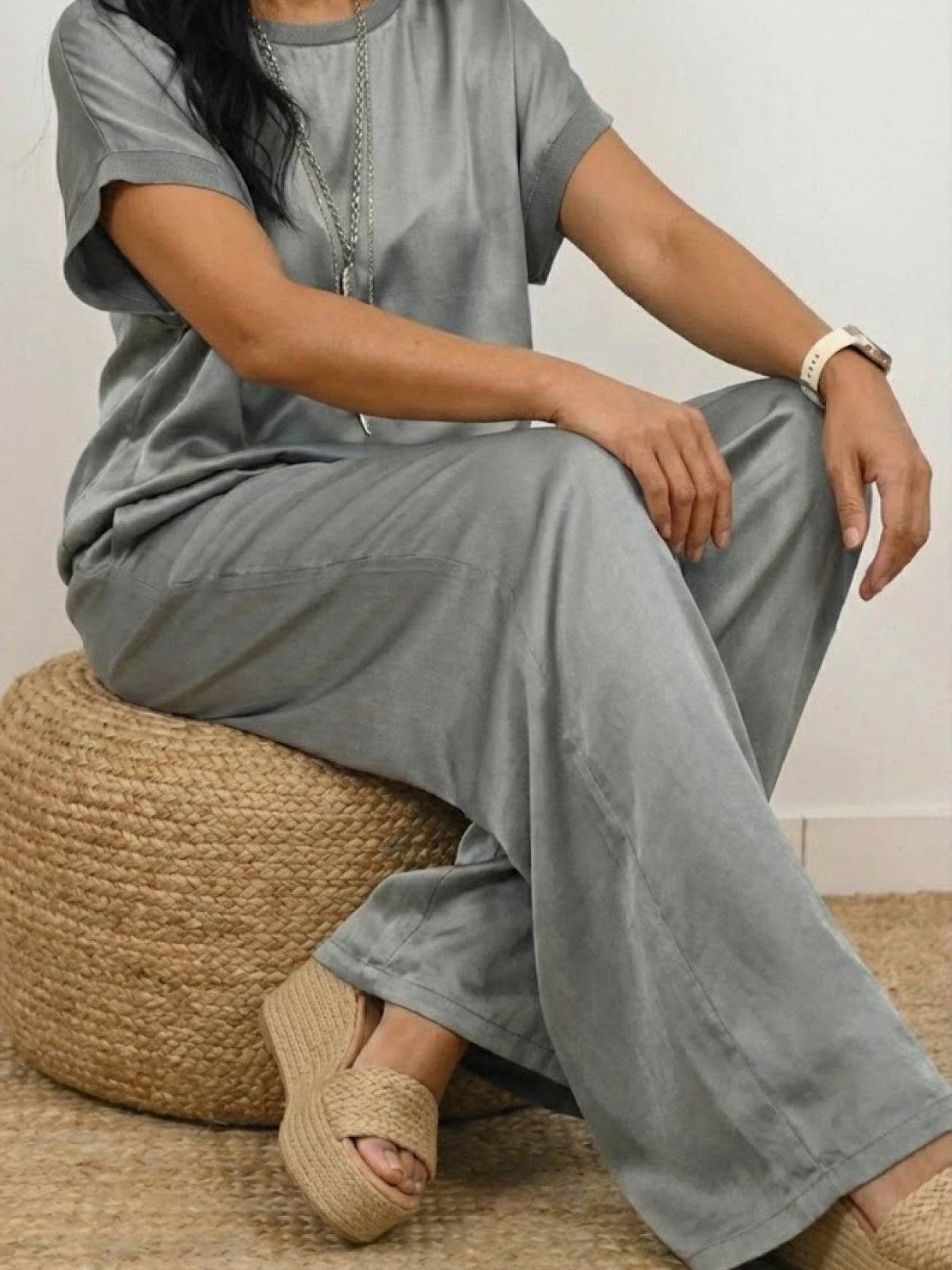 Woman modeling Silken Escape Satin Two-Piece Set with wide-leg pants and fitted top in flowing satin fabric