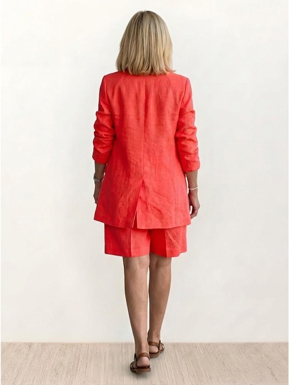 Woman wearing a stylish blazer and shorts two-piece set in vibrant color