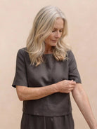 Woman wearing a loose fit co-ord set with a soft-tailored top and wide-leg bottoms in relaxed style