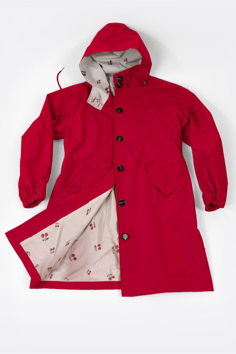 Red oversized Rain Couture Windbreaker with hood and floral patterned interior lining.