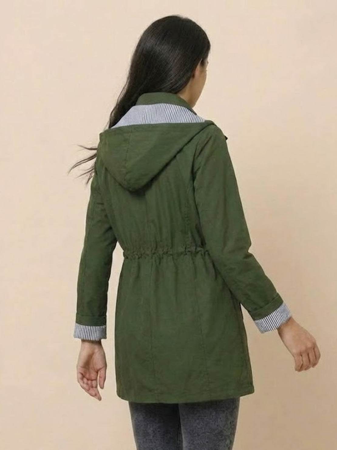 Back view of a woman wearing a green water resistant windbreaker with hood and striped inner lining