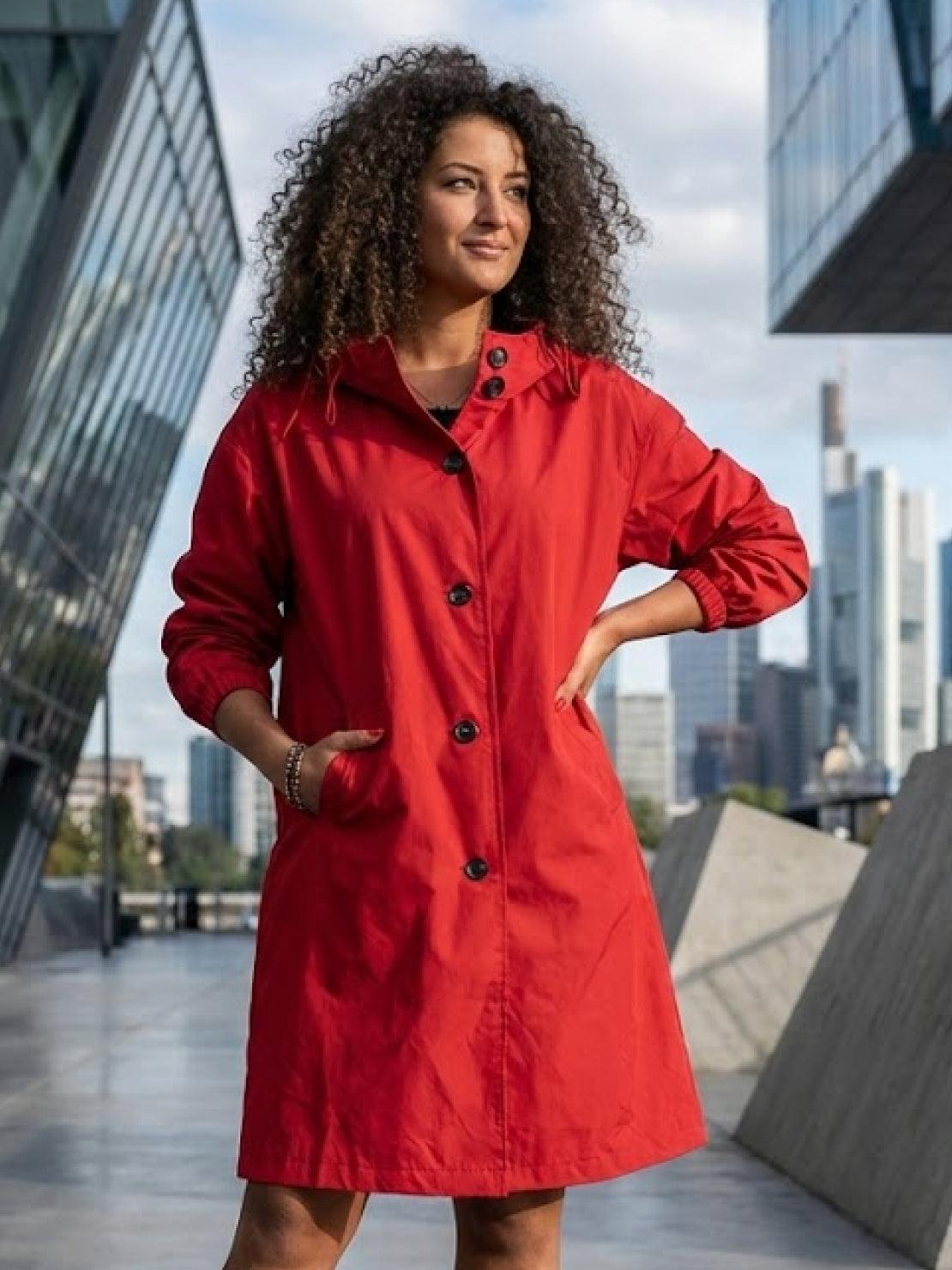 Water-resistant oversized hooded windbreaker rain jacket on mannequin