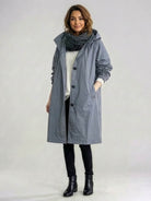 water-resistant oversized hooded windbreaker rain jacket on a mannequin with front zipper and pockets